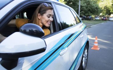 Woman learning to drive a car and going reverse. Woman learning to drive a car and going reverse.