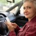 Portrait of elegant modern female pensioner using electronic gadget inside automobile. Stylish mature woman sitting in driver seat of vehicle she rented via car sharing application on her phone
